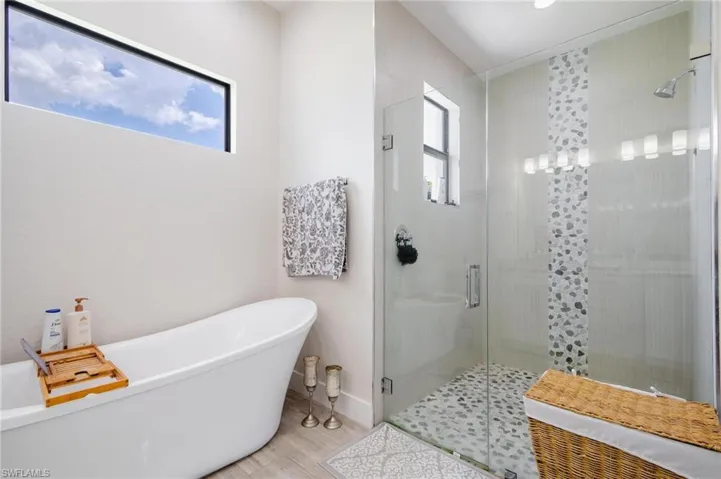 Bathroom featuring shower with separate bathtub