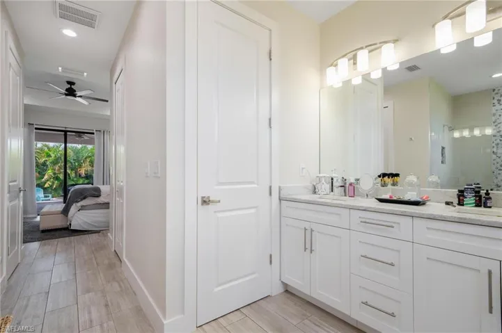 Bathroom with double sink vanity and ceiling fan