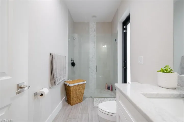Bathroom with vanity, toilet, tile patterned floors, and walk in shower