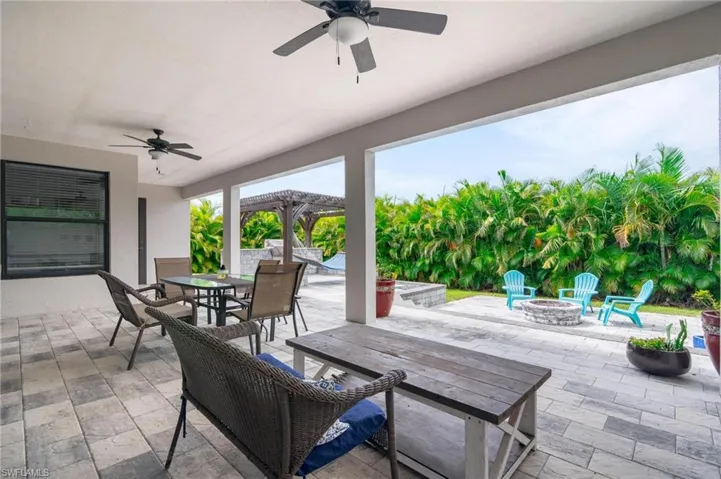 View of patio / terrace with a fire pit and ceiling fan