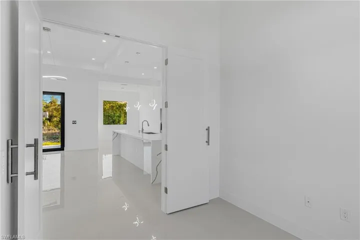 Corridor featuring a sink, baseboards, and recessed lighting