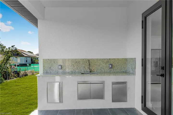 View of patio / terrace with an outdoor kitchen and a sink
