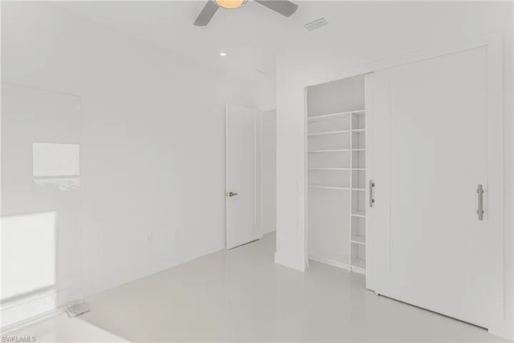 Unfurnished bedroom with visible vents, recessed lighting, ceiling fan, tile patterned flooring, and a closet