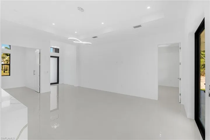 Spare room featuring visible vents, recessed lighting, and a raised ceiling