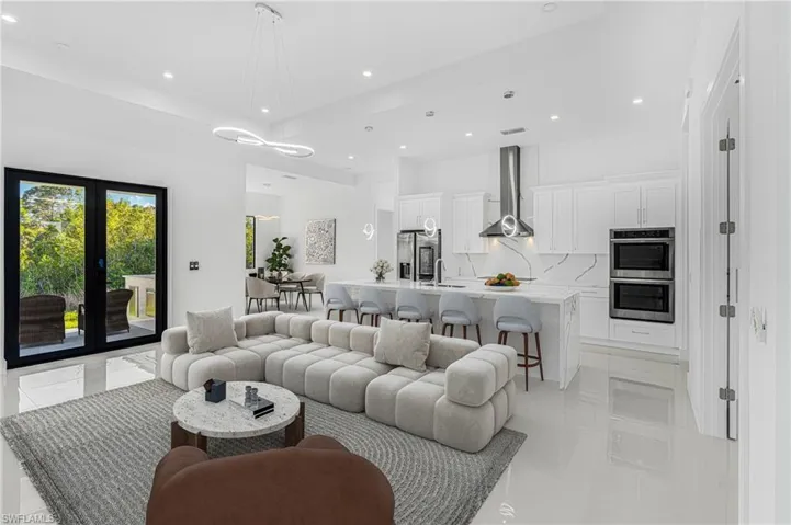 Living area with recessed lighting, visible vents, and french doors