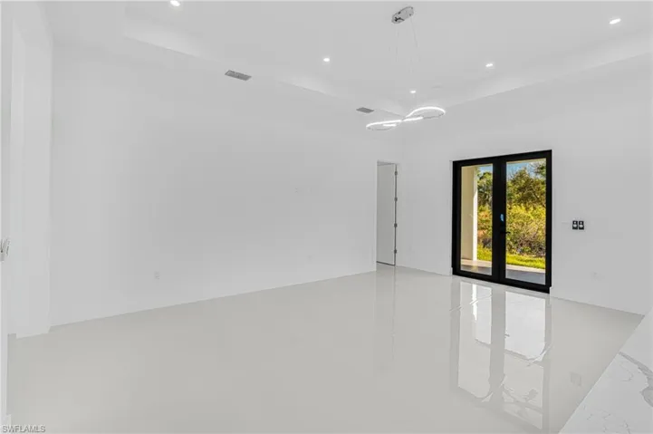Spare room featuring recessed lighting, visible vents, and french doors