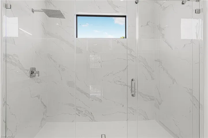 Bathroom featuring a marble finish shower