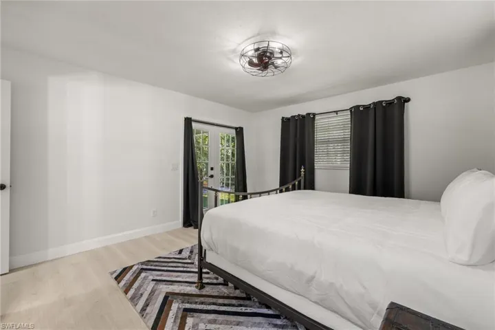 Bedroom featuring light wood-type flooring, access to outside, and french doors