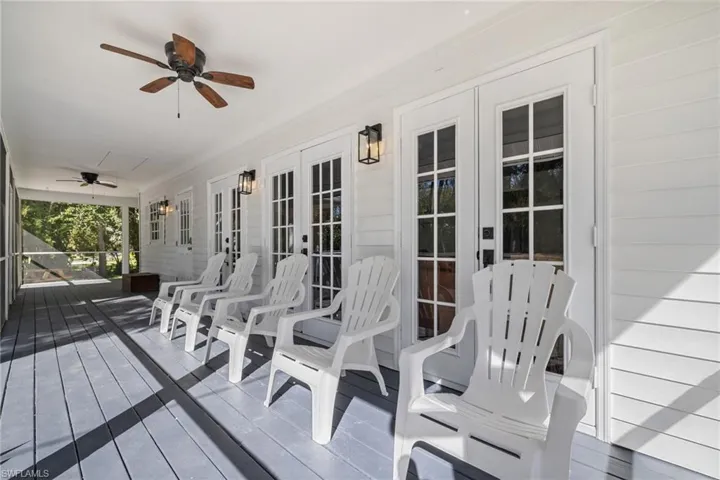 Wooden deck featuring a ceiling fan and french doors