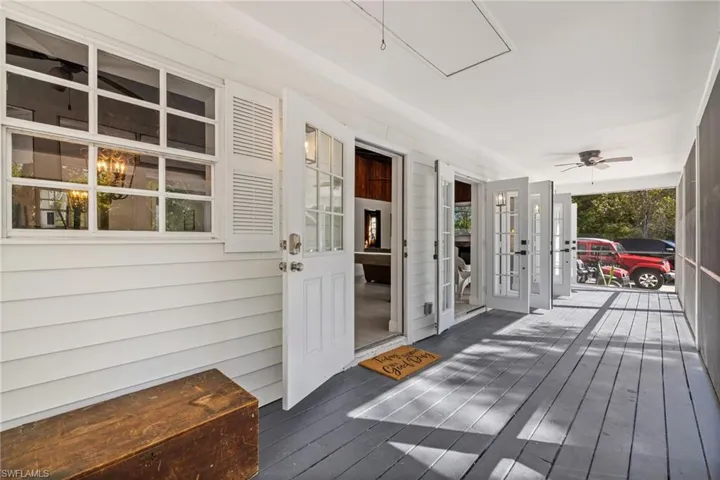 Wooden porch featuring a ceiling fan