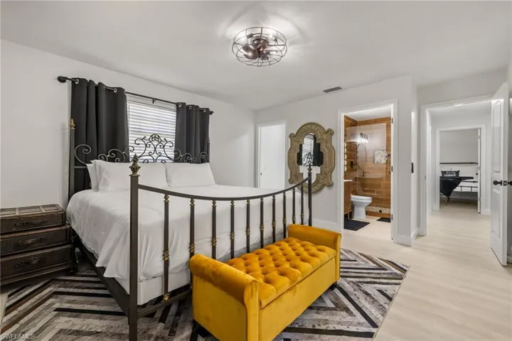 Bedroom with wood finished floors and ensuite bathroom