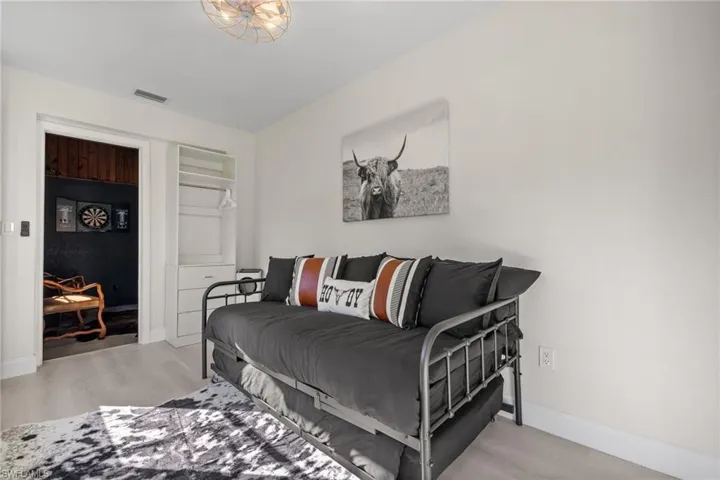 Bedroom with light wood-style floors and baseboards