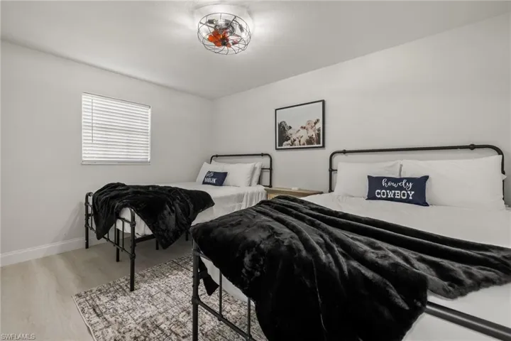 Bedroom featuring light wood-style floors and baseboards
