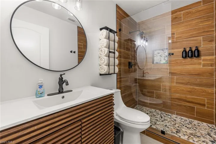 Full bathroom with vanity and a walk in shower