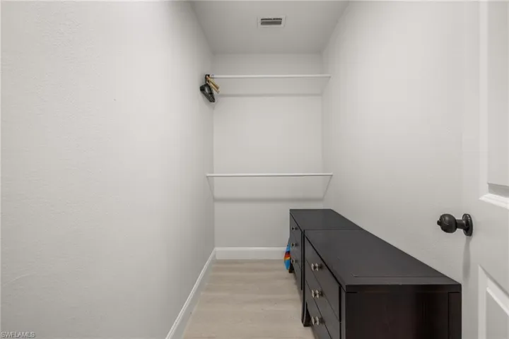 Walk in closet featuring light wood-type flooring