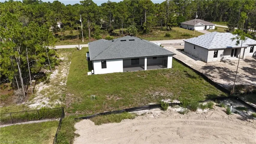 Single-story residence featuring a gray shingle roof and white exterior walls