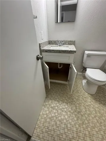 Bathroom with a textured wall and vanity
