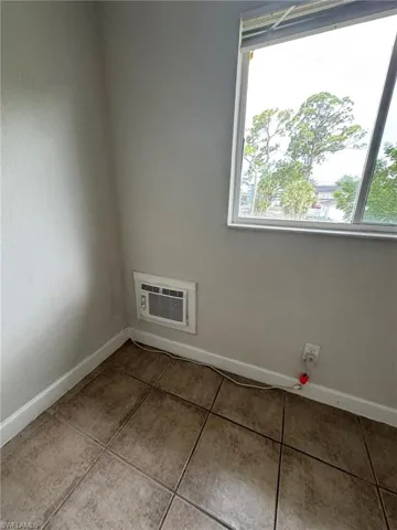 Spare room featuring baseboards and light tile patterned floors