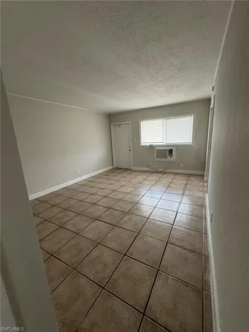 Spare room featuring tile patterned floors and a textured ceiling
