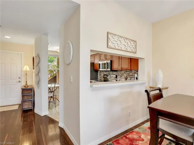 Dining space with dark wood-style flooring, recessed lighting, and baseboards