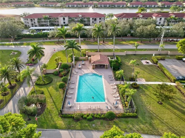 Aerial view of a pool area and a large body of water