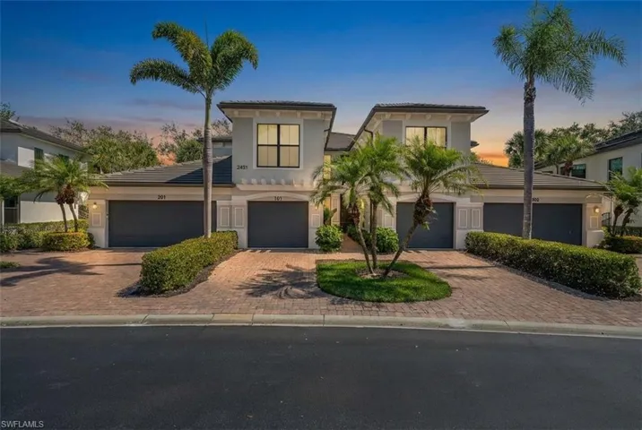 Mediterranean / spanish house with a tiled roof, stucco siding, and decorative driveway