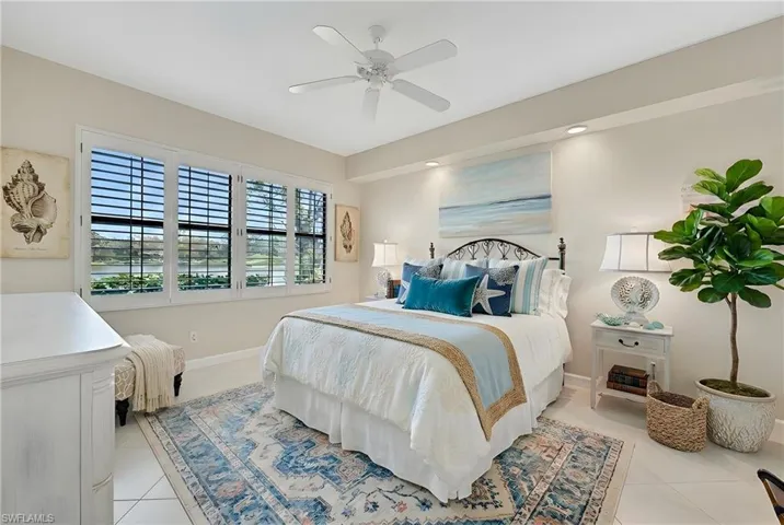 Bedroom with ceiling fan and light tile patterned flooring