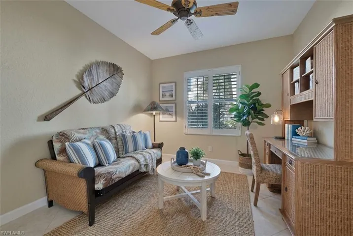Sitting room featuring ceiling fan and light tile patterned floors