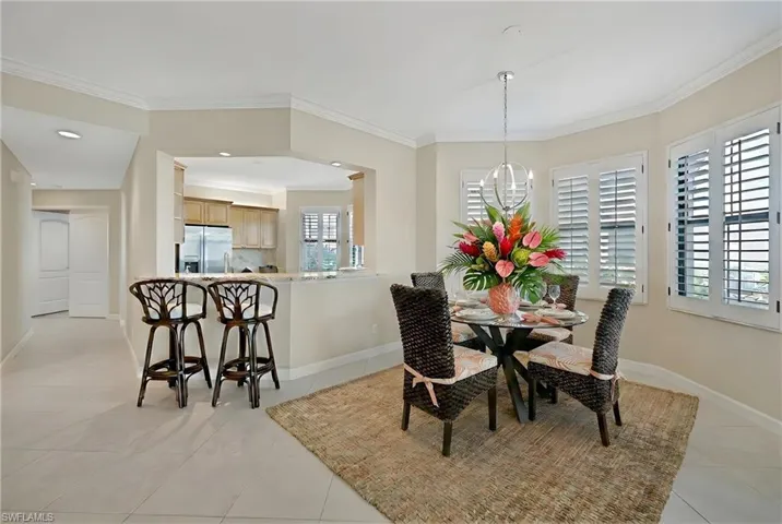 Dining room featuring ornamental molding and light tile patterned flooring