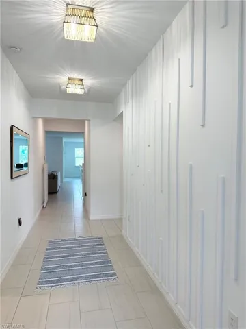 Hallway with light tile patterned floors