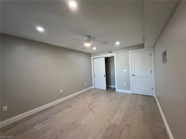 Unfurnished bedroom with light wood-style flooring, recessed lighting, baseboards, and visible vents