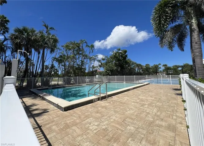 Community pool featuring a patio