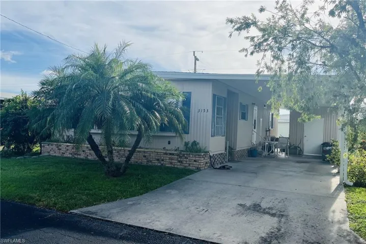 View of side of property featuring a carport