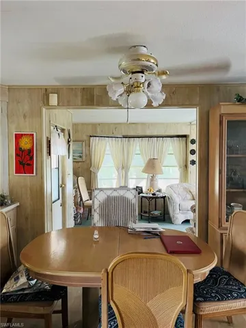 Living area featuring wooden walls and wood finished floors