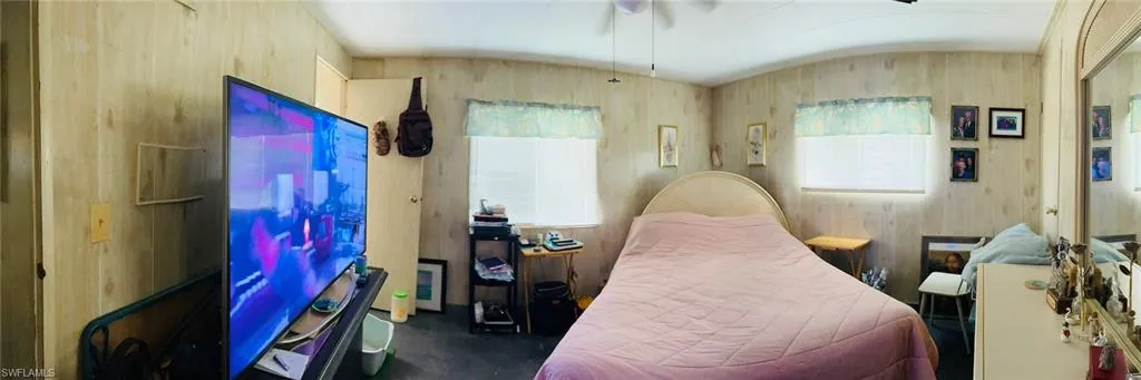 Bedroom featuring wood walls