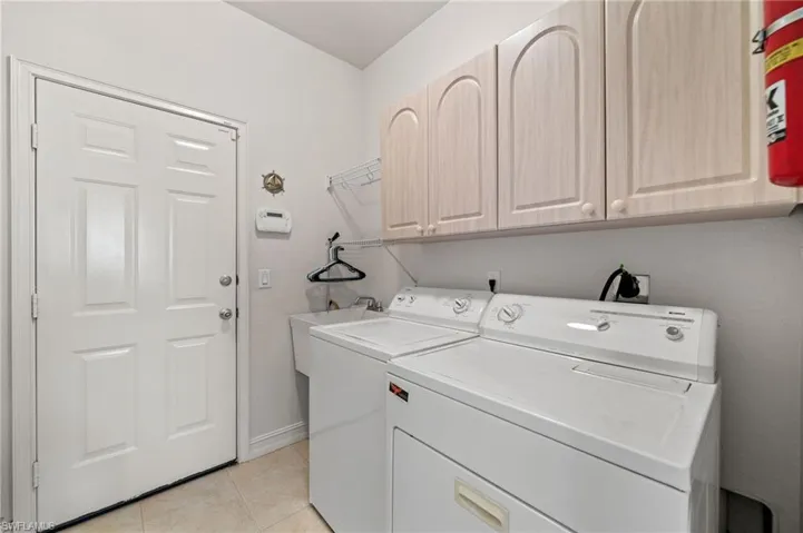 Laundry room with sink and access to garage