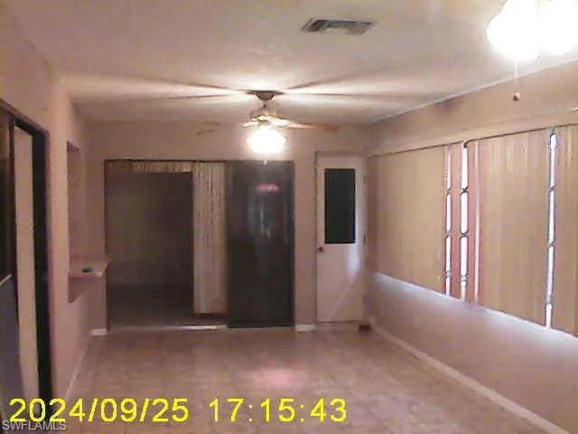 Spare room featuring a ceiling fan and baseboards