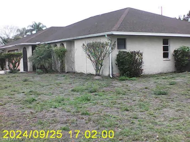 View of side of home featuring stucco siding