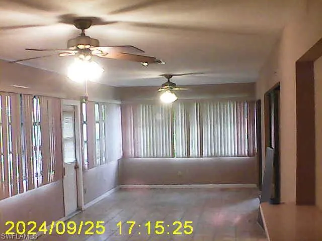 Empty room with a ceiling fan and baseboards