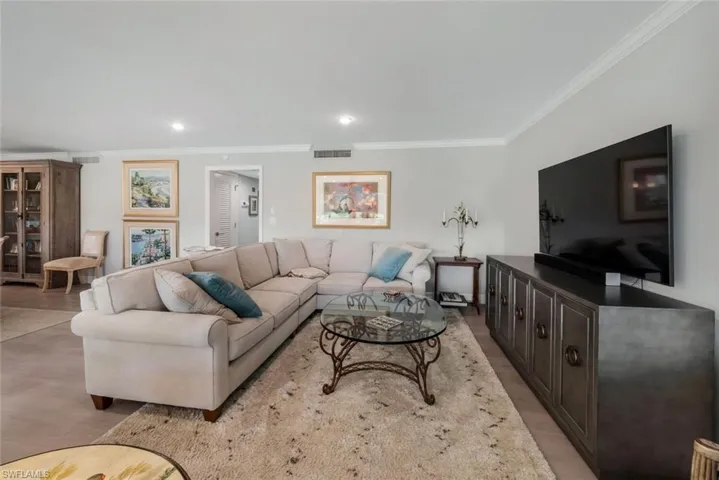 Living room featuring ornamental molding and light wood-type flooring