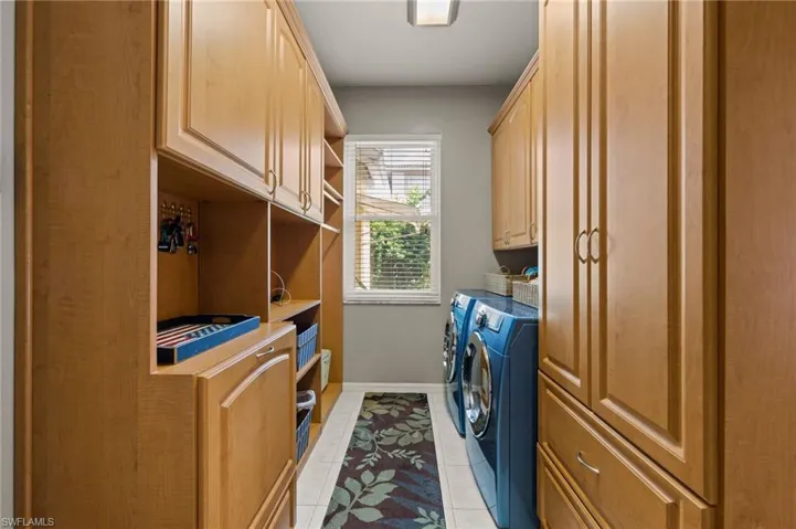 Laundry Room with lots of cabinetry & a window