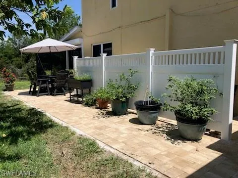 Side yard w paver stone deck.