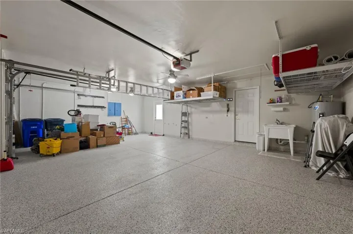 3 car garage with epoxy floor and hanging shelves