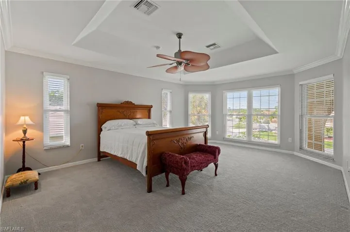 Primary Bedroom with Floor to Celling bay windows and tgray Ceiling