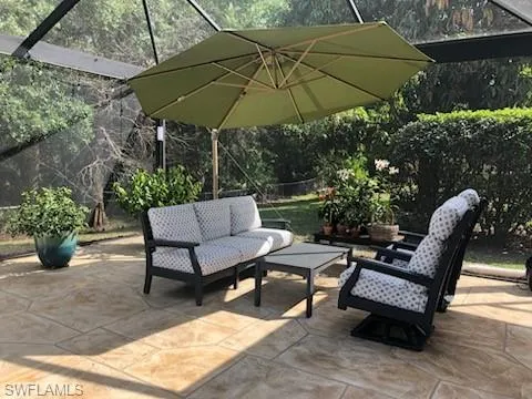 Lanai deck area, shown with seating and umbrella.