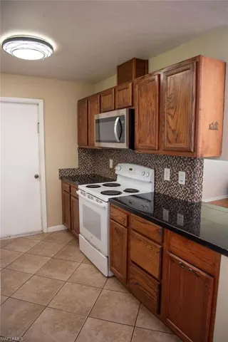 Living area with light wood finished floors, ceiling fan, and plenty of natural light