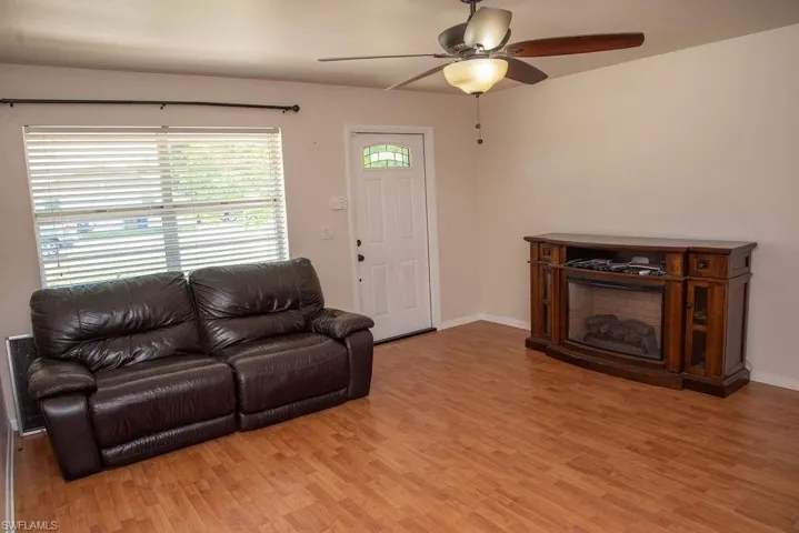 Living area with light wood-type flooring and ceiling fan