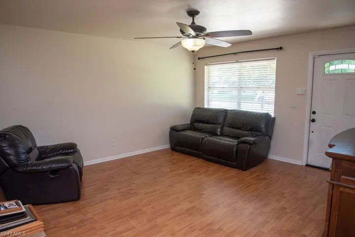 Unfurnished bedroom featuring wood finished floors, a closet, and a ceiling fan