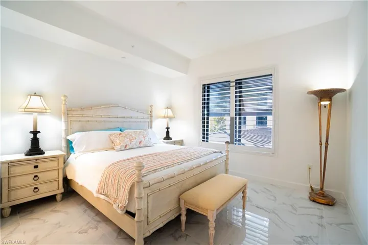 Bedroom with light marble finish floors
