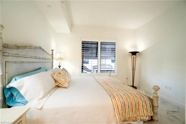 Bedroom with baseboards and marble finish flooring
